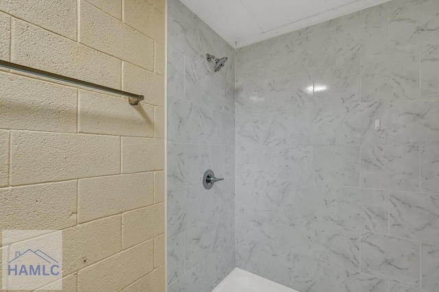 bathroom with a tile shower