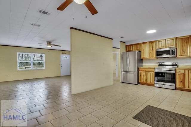 kitchen featuring ceiling fan, light tile patterned floors, and stainless steel appliances