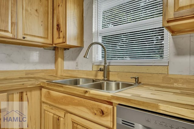 kitchen featuring dishwasher, plenty of natural light, sink, and light brown cabinetry