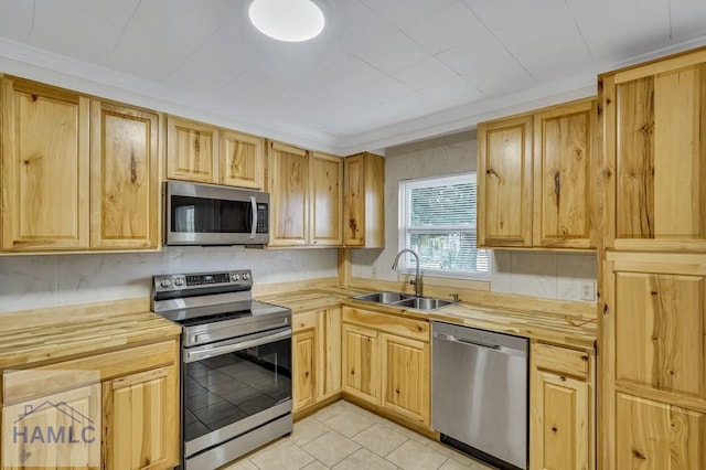 kitchen with light brown cabinets, sink, and stainless steel appliances