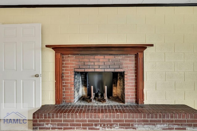 interior details with crown molding and a fireplace