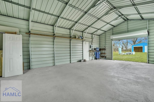 garage featuring a yard and a carport