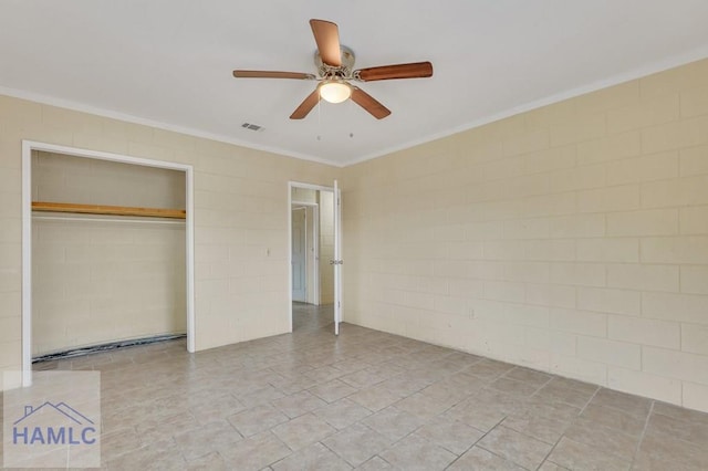 unfurnished bedroom with ceiling fan, a closet, and crown molding