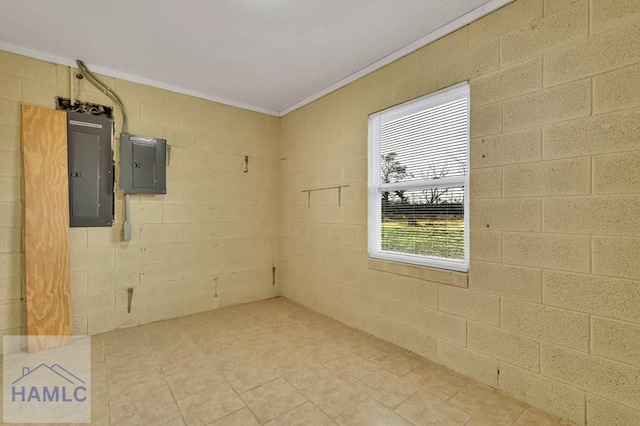 empty room featuring electric panel and ornamental molding