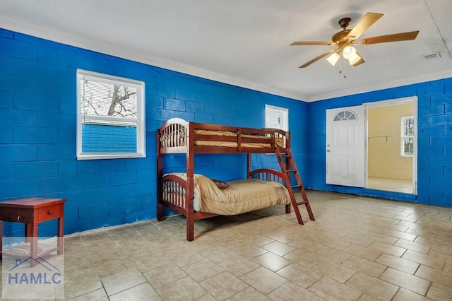 bedroom with ceiling fan and ornamental molding