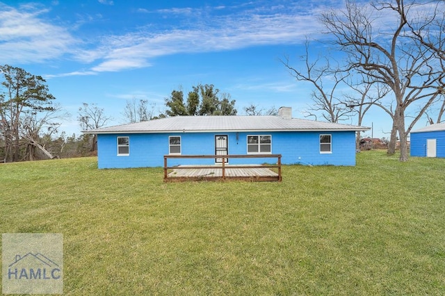 view of front of home with a front yard and a deck