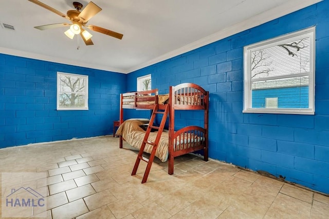 bedroom featuring multiple windows, ceiling fan, and ornamental molding