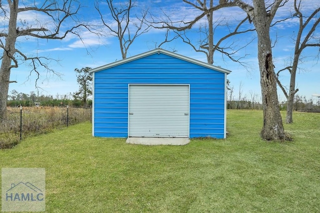 view of outbuilding with a lawn and a garage