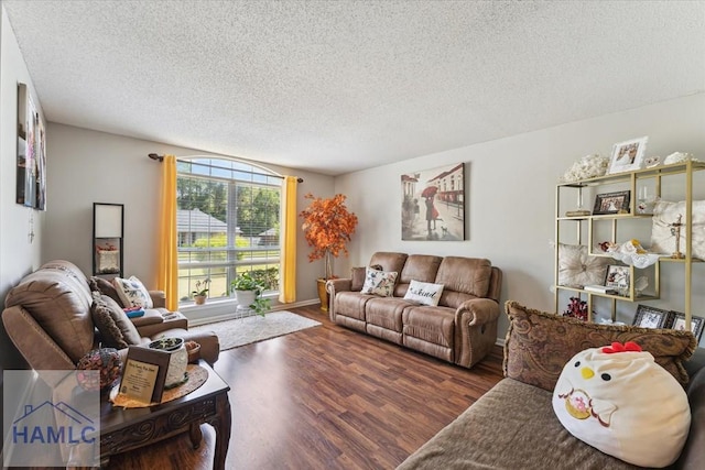 living area with a textured ceiling and wood finished floors