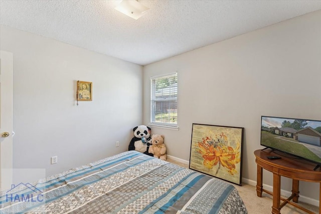 bedroom featuring baseboards, carpet, and a textured ceiling
