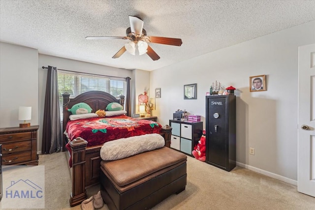 bedroom with baseboards, a ceiling fan, a textured ceiling, and light colored carpet