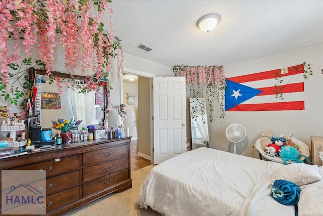 bedroom featuring visible vents and a textured ceiling
