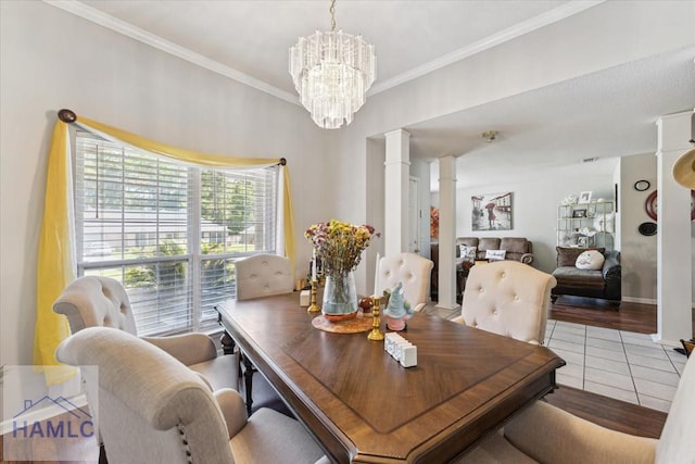 dining space featuring ornate columns, crown molding, light tile patterned flooring, and a chandelier