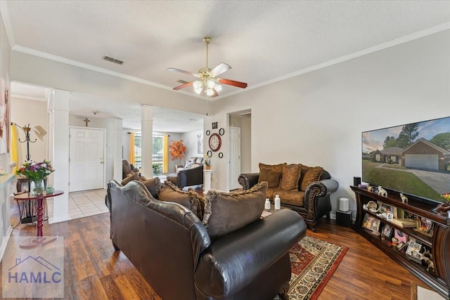 living room with visible vents, decorative columns, ceiling fan, and wood finished floors