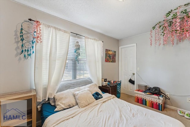 carpeted bedroom with a textured ceiling