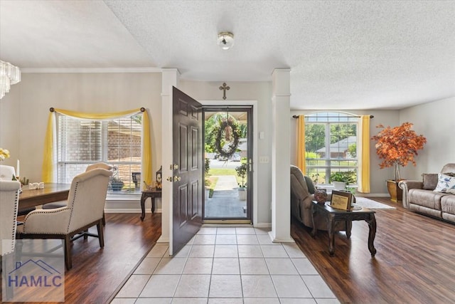 foyer featuring baseboards and a textured ceiling