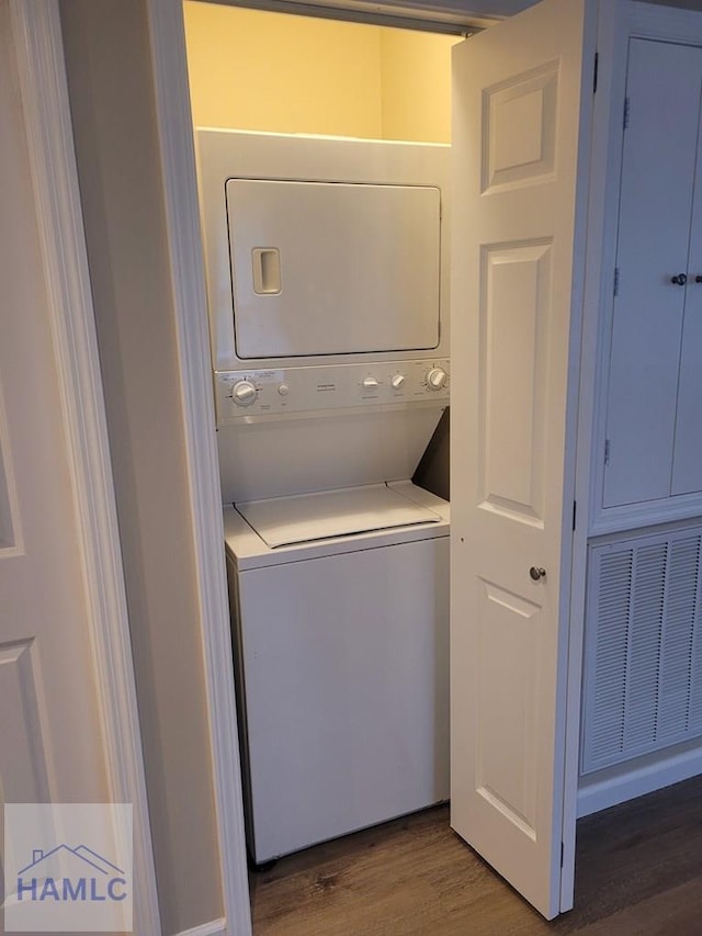 2922 7th St, Columbus, GA 31906 - washroom with estacked washer and dryer and wood finished floors