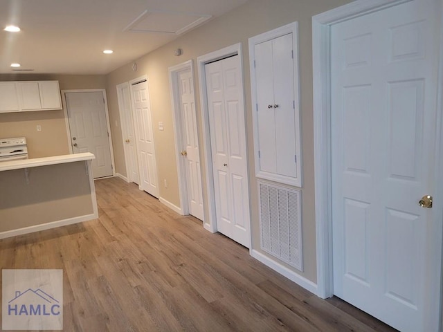 2922 7th St, Columbus, GA 31906 - kitchen featuring light wood finished floors, recessed lighting, white electric range, white cabinets, and light countertops