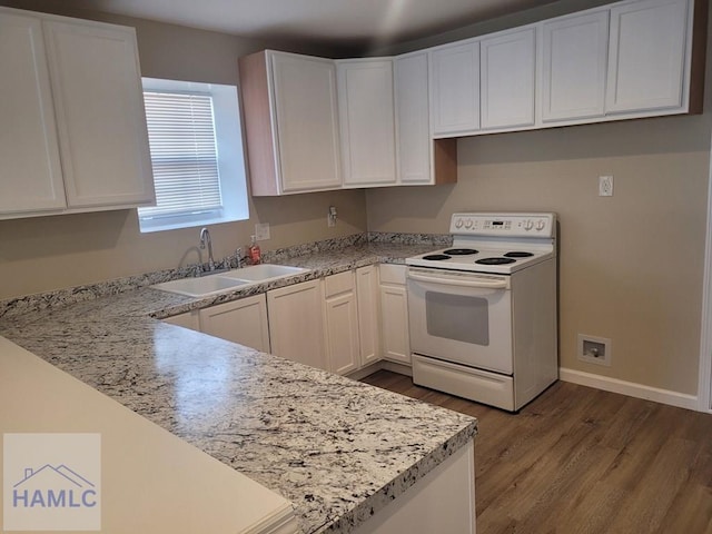 2922 7th St, Columbus, GA 31906 - kitchen featuring white range with electric cooktop, dark wood finished floors, light countertops, and white cabinets
