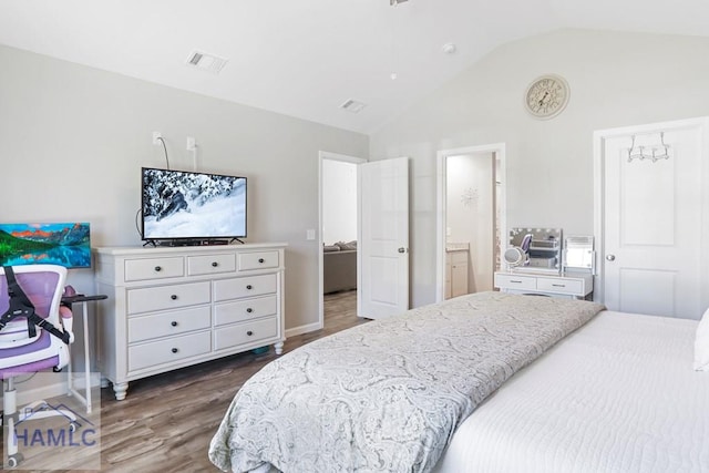 bedroom featuring dark wood finished floors, visible vents, baseboards, and vaulted ceiling