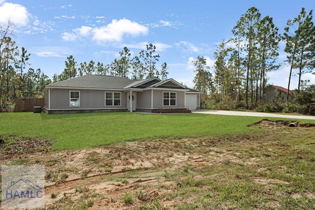 single story home with a front lawn, fence, concrete driveway, central AC, and a garage