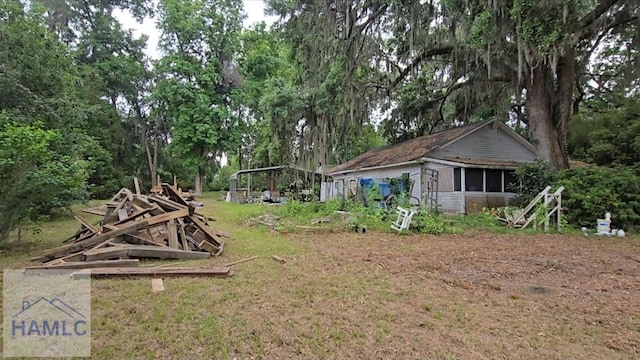86 Hidden Dr, Midway, GA 31320 - view of grassy yard with a sunroom