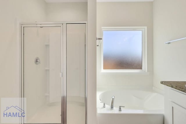 bathroom with vanity and independent shower and bath