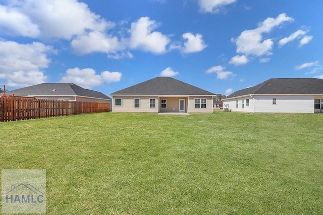 rear view of house featuring a yard and a patio area