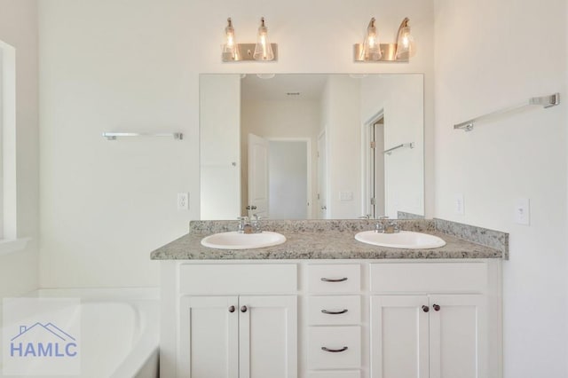 bathroom featuring vanity and a washtub