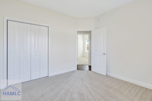 unfurnished bedroom with carpet floors and a closet