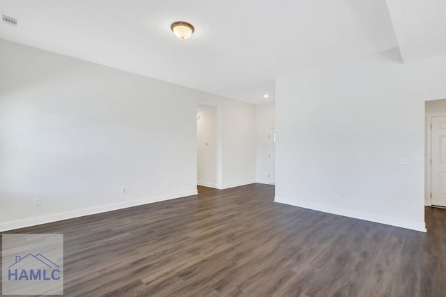 empty room featuring dark hardwood / wood-style flooring