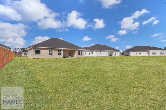 back of house featuring a lawn