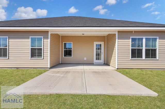 rear view of property featuring a yard