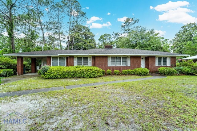 153 Drennon Dr, Jesup, GA 31545 - single story home with a front lawn, an attached carport, and brick siding