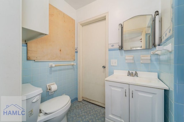 153 Drennon Dr, Jesup, GA 31545 - bathroom with tile walls, toilet, vanity, and tile patterned floors