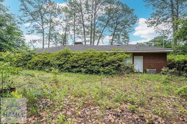 153 Drennon Dr, Jesup, GA 31545 - back of property featuring brick siding and a chimney