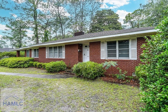 153 Drennon Dr, Jesup, GA 31545 - ranch-style home featuring brick siding, a front yard, and a chimney