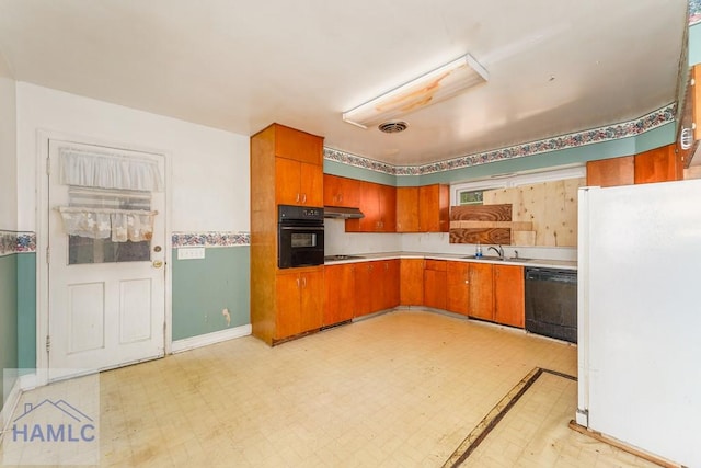 153 Drennon Dr, Jesup, GA 31545 - kitchen featuring black appliances, light countertops, light floors, and brown cabinets