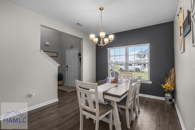 26 Sunflower Cir, Ludowici, GA 31316 - dining space with dark wood-type flooring, a chandelier, and baseboards