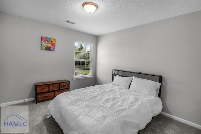 26 Sunflower Cir, Ludowici, GA 31316 - bedroom featuring carpet flooring, a textured ceiling, and baseboards
