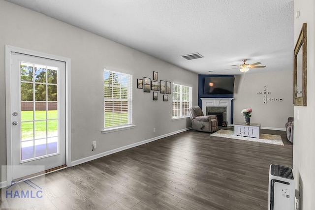 26 Sunflower Cir, Ludowici, GA 31316 - unfurnished living room with a high end fireplace, ceiling fan, wood finished floors, baseboards, and a textured ceiling