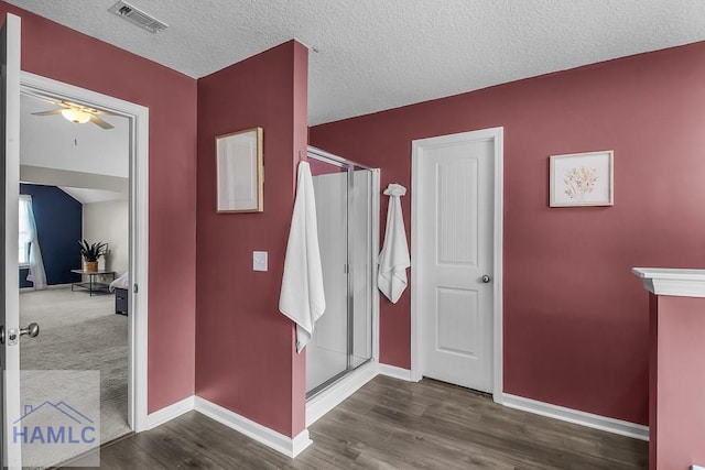 26 Sunflower Cir, Ludowici, GA 31316 - full bathroom with ceiling fan, baseboards, a shower stall, and a textured ceiling