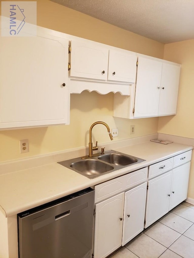 kitchen featuring white cabinets, a textured ceiling, sink, light tile patterned floors, and dishwasher