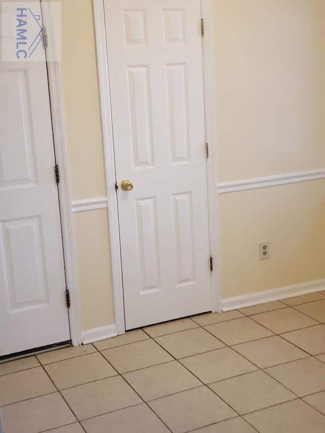 interior space featuring light tile patterned floors and a closet