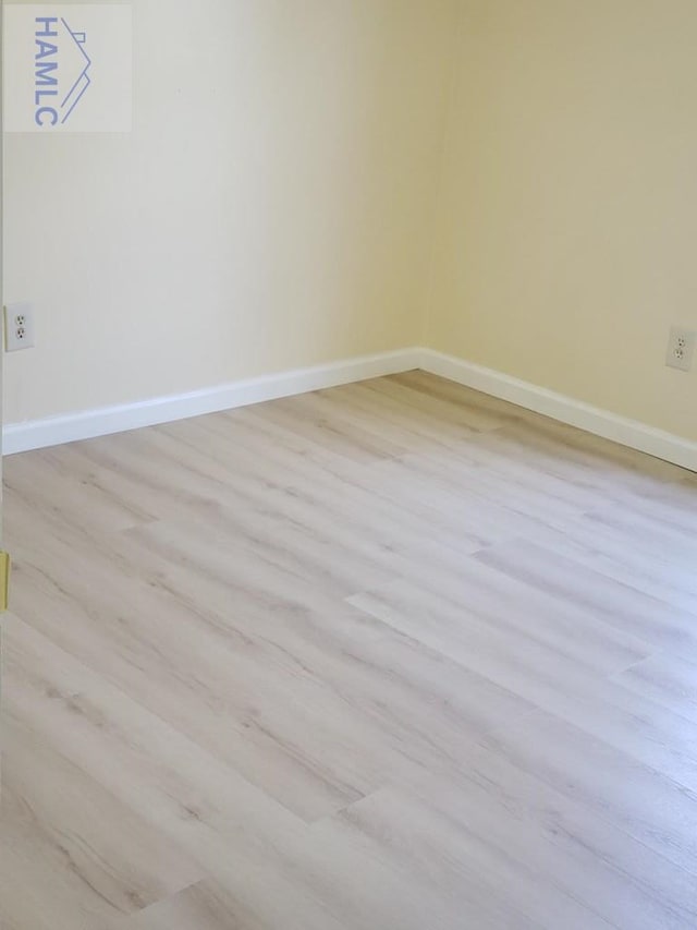 spare room with light wood-type flooring