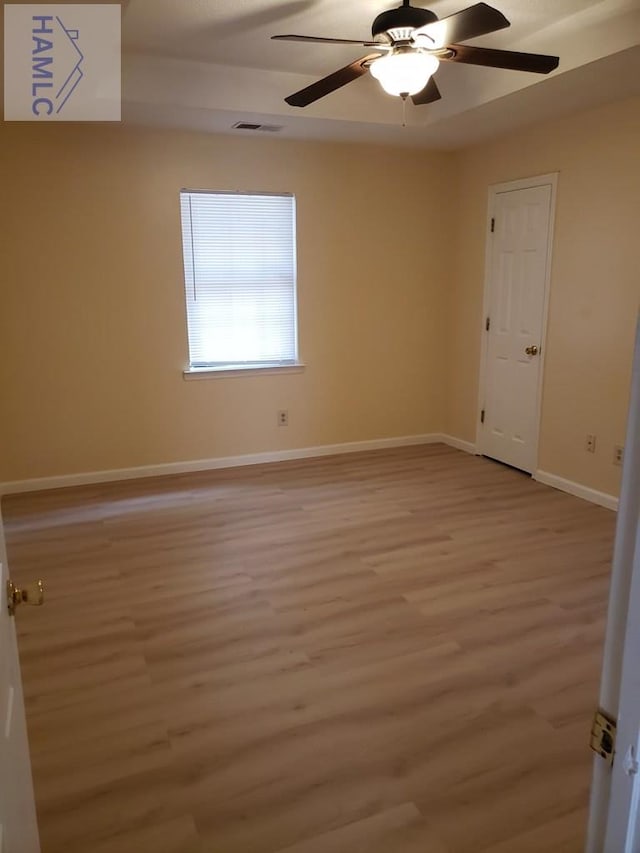 empty room with light hardwood / wood-style flooring and ceiling fan