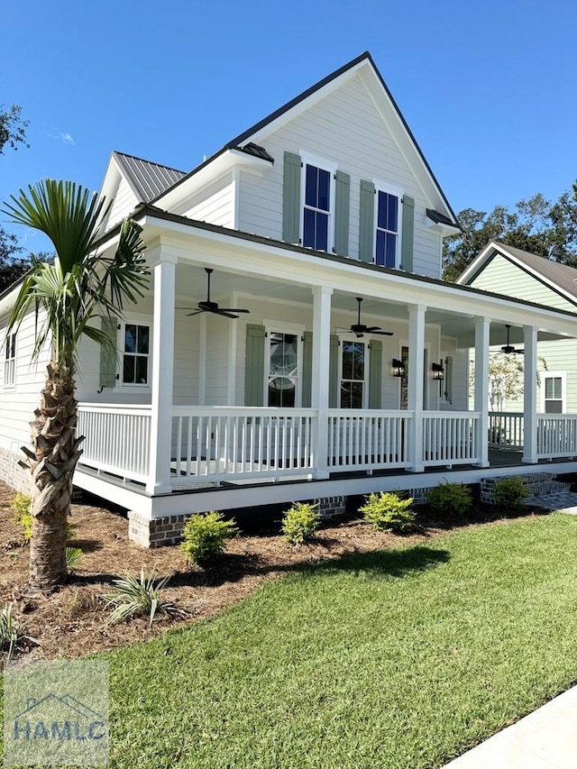 farmhouse featuring covered porch and a front lawn