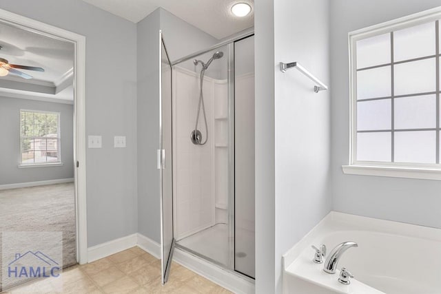 42 Kinlock Ct, Midway, GA 31320 - full bathroom featuring a stall shower, a garden tub, a ceiling fan, and a tray ceiling