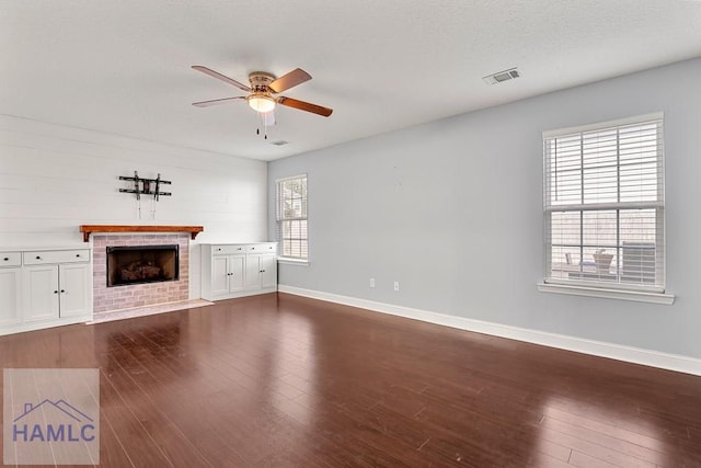 42 Kinlock Ct, Midway, GA 31320 - unfurnished living room featuring ceiling fan, a fireplace, and dark wood-type flooring
