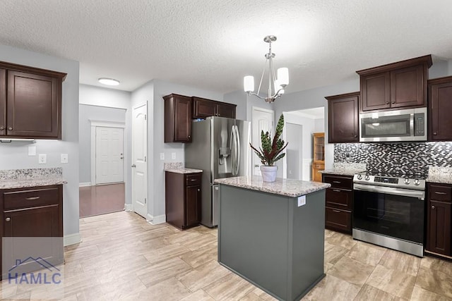 42 Kinlock Ct, Midway, GA 31320 - kitchen featuring appliances with stainless steel finishes, tasteful backsplash, a chandelier, dark brown cabinets, and a textured ceiling